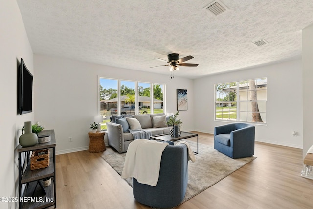 4923 Lofty Pines Cir E, Jacksonville, FL 32210 - living area featuring a ceiling fan, wood finished floors, a textured ceiling, and baseboards