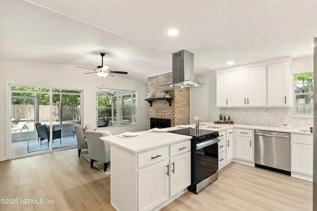 4923 Lofty Pines Cir E, Jacksonville, FL 32210 - kitchen with stainless steel dishwasher, range with electric cooktop, a peninsula, extractor fan, and light wood finished floors