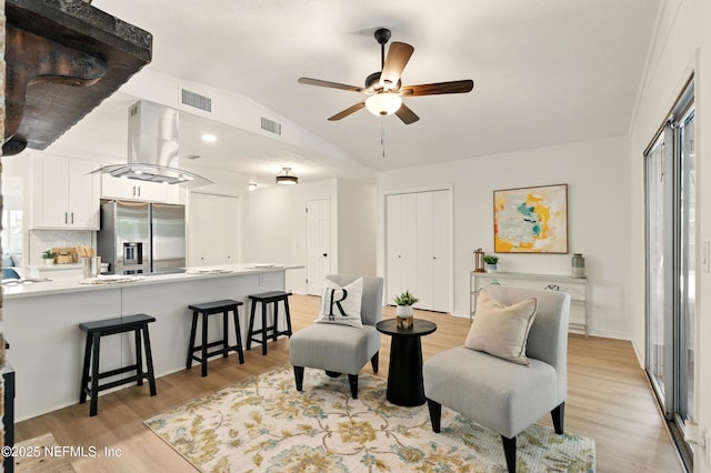 4923 Lofty Pines Cir E, Jacksonville, FL 32210 - living area featuring vaulted ceiling, ceiling fan, and light wood finished floors