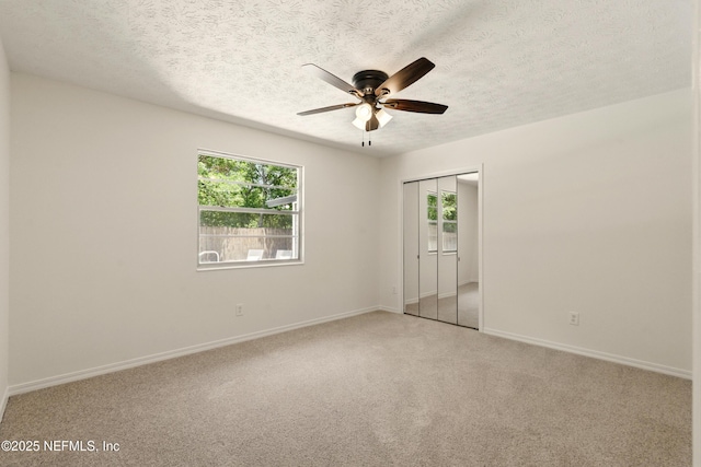 4923 Lofty Pines Cir E, Jacksonville, FL 32210 - spare room featuring plenty of natural light, ceiling fan, a textured ceiling, light colored carpet, and baseboards