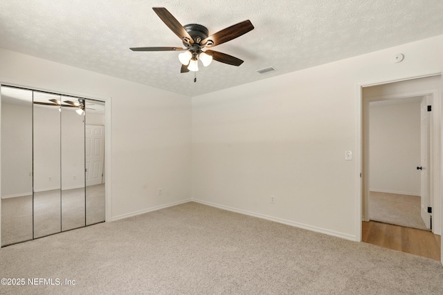 4923 Lofty Pines Cir E, Jacksonville, FL 32210 - unfurnished bedroom featuring carpet flooring, a textured ceiling, a ceiling fan, baseboards, and a closet