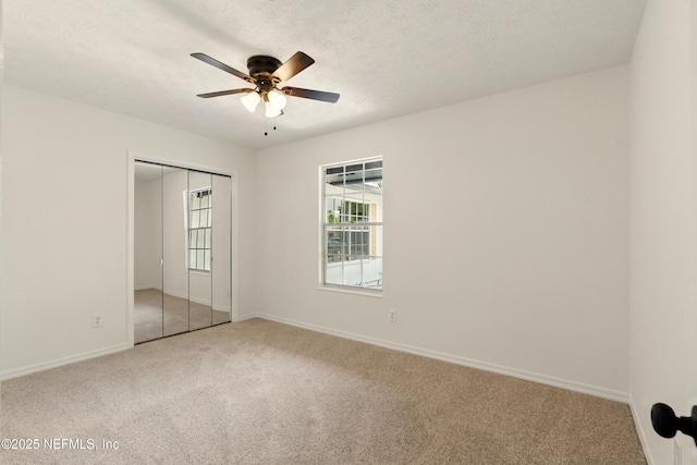 4923 Lofty Pines Cir E, Jacksonville, FL 32210 - unfurnished bedroom featuring carpet, baseboards, a closet, ceiling fan, and a textured ceiling