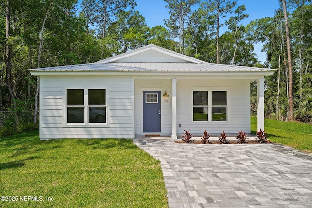 view of front of home with a front lawn, a porch, and metal roof