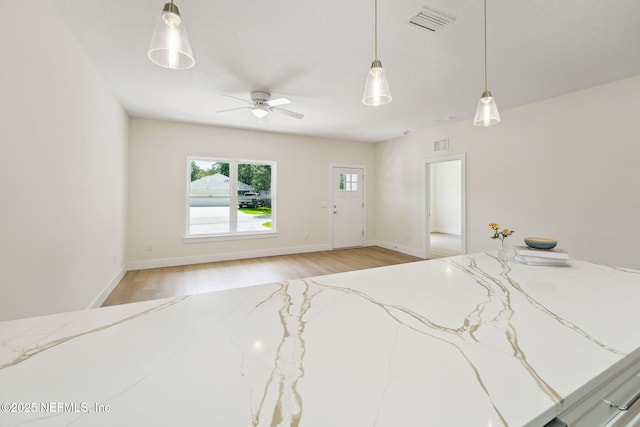 unfurnished bedroom featuring light wood-style flooring and baseboards