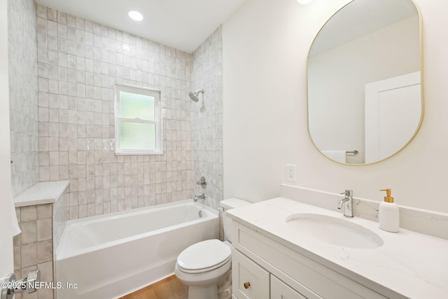 bathroom with toilet, shower / bath combination, and vanity
