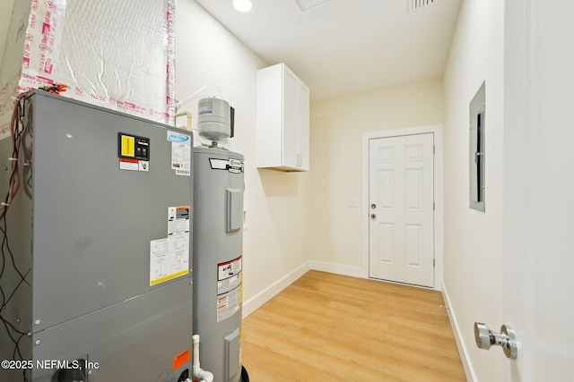 utility room with electric water heater and heating unit