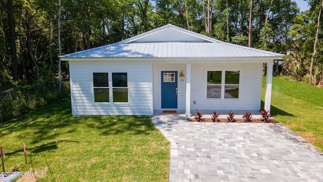 bungalow-style house with a porch, a front yard, and metal roof