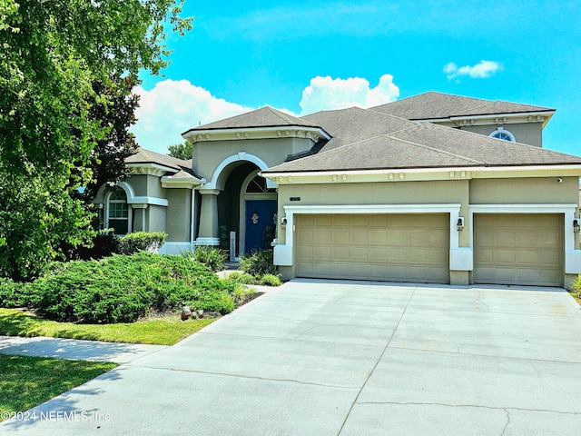 3051 Paddle Creek Dr, Green Cove Springs, FL 32043 - view of front of property featuring an attached garage, stucco siding, driveway, and a shingled roof