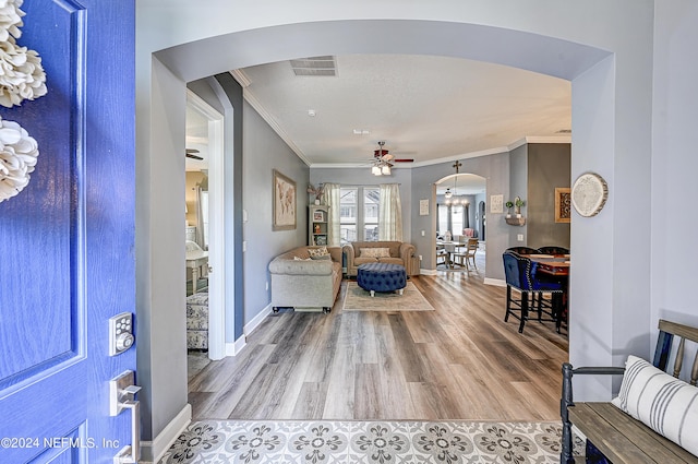 3051 Paddle Creek Dr, Green Cove Springs, FL 32043 - entryway featuring arched walkways, ornamental molding, ceiling fan, wood finished floors, and baseboards