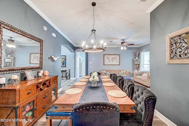 3051 Paddle Creek Dr, Green Cove Springs, FL 32043 - dining room featuring a ceiling fan, arched walkways, crown molding, a chandelier, and baseboards
