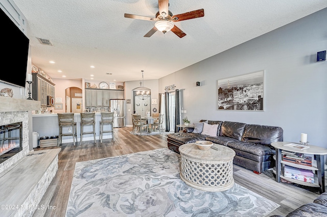 3051 Paddle Creek Dr, Green Cove Springs, FL 32043 - living area featuring ceiling fan, light wood-style flooring, arched walkways, a textured ceiling, and recessed lighting