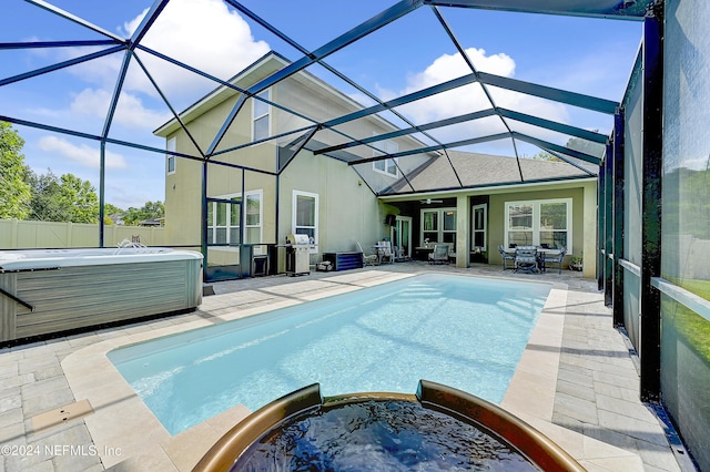 3051 Paddle Creek Dr, Green Cove Springs, FL 32043 - view of swimming pool with a patio area, a grill, a ceiling fan, glass enclosure, and a pool with connected hot tub