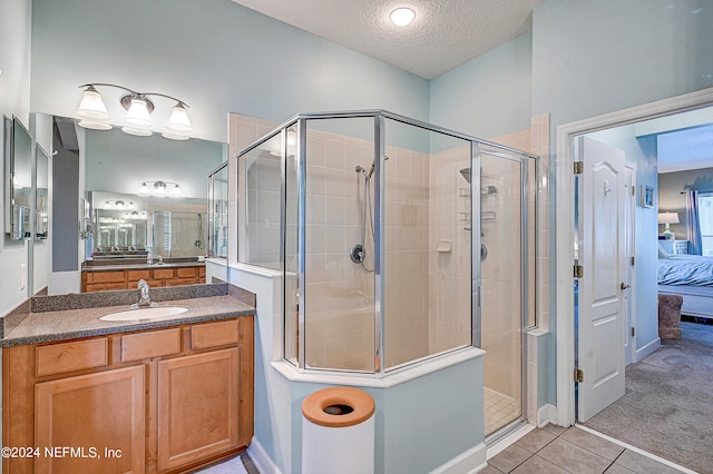 3051 Paddle Creek Dr, Green Cove Springs, FL 32043 - ensuite bathroom featuring a shower stall, a textured ceiling, tile patterned flooring, and vanity