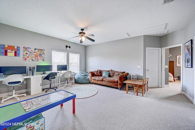 3051 Paddle Creek Dr, Green Cove Springs, FL 32043 - carpeted living room featuring an office area, ceiling fan, attic access, a textured ceiling, and baseboards