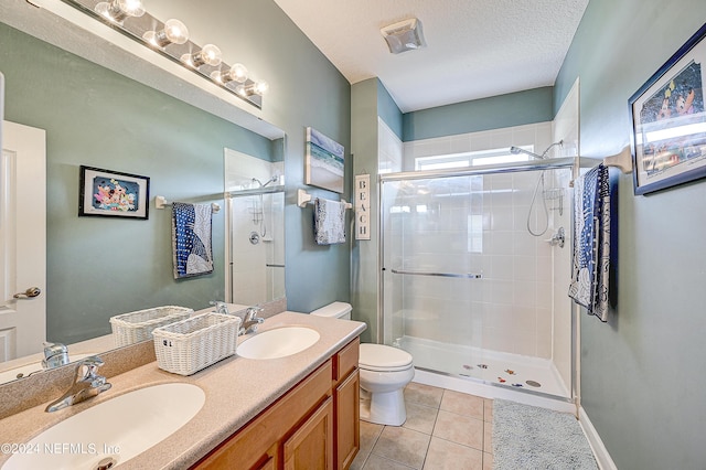 3051 Paddle Creek Dr, Green Cove Springs, FL 32043 - full bathroom with a shower stall, tile patterned floors, toilet, double vanity, and a textured ceiling