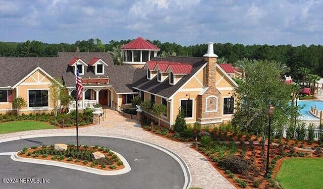 3051 Paddle Creek Dr, Green Cove Springs, FL 32043 - view of front facade featuring a chimney and stone siding