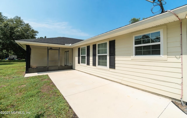 2253 S Mimosa Ave, Middleburg, FL 32068 - back of house with a sunroom, a patio area, and a lawn