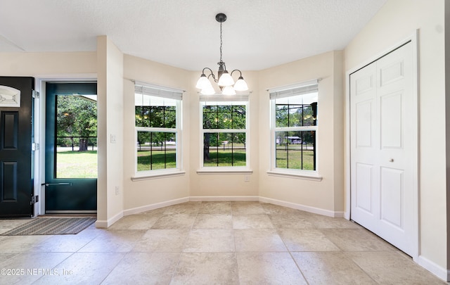 2253 S Mimosa Ave, Middleburg, FL 32068 - unfurnished dining area with a chandelier, baseboards, and a textured ceiling