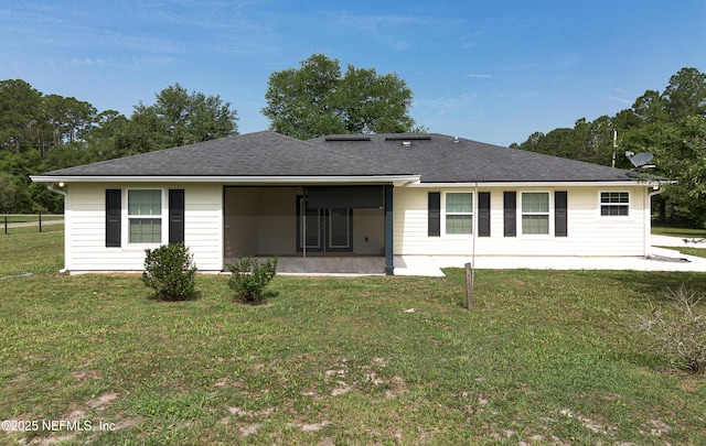 2253 S Mimosa Ave, Middleburg, FL 32068 - back of house with a sunroom, a yard, and roof with shingles