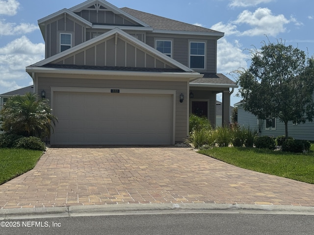 222 River Mist Dr, Saint Augustine, FL 32095 - view of front of house with decorative driveway, a garage, and roof with shingles