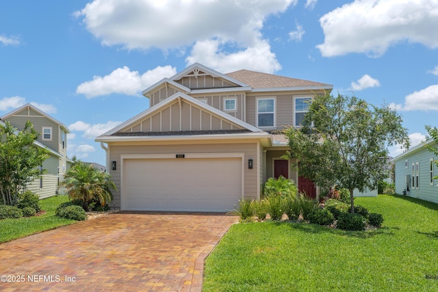 222 River Mist Dr, Saint Augustine, FL 32095 - craftsman-style home with decorative driveway, a front yard, a garage, and roof with shingles