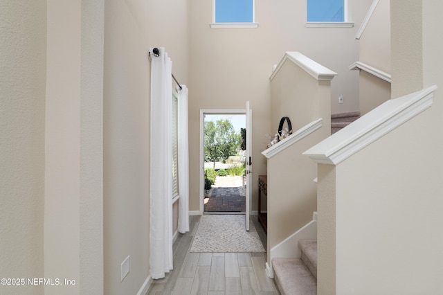 222 River Mist Dr, Saint Augustine, FL 32095 - entrance foyer with stairs, wood finished floors, a towering ceiling, and baseboards