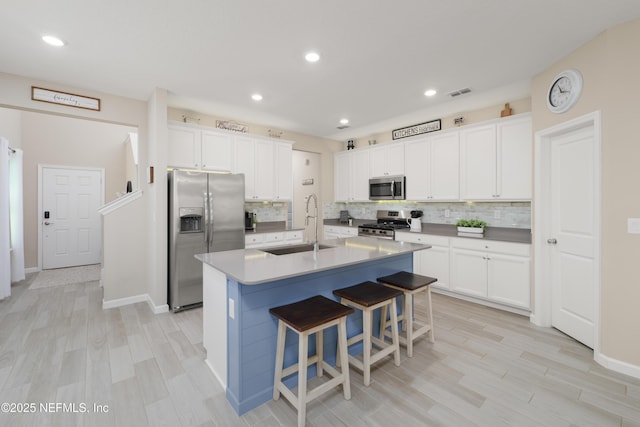222 River Mist Dr, Saint Augustine, FL 32095 - kitchen with appliances with stainless steel finishes, a sink, tasteful backsplash, a kitchen bar, and recessed lighting