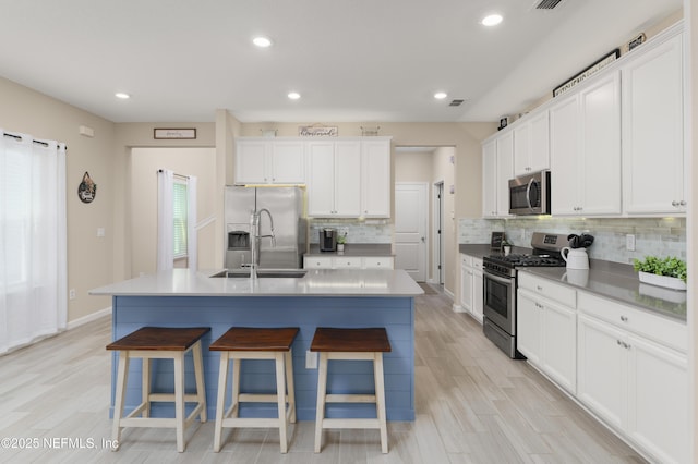 222 River Mist Dr, Saint Augustine, FL 32095 - kitchen featuring stainless steel appliances, decorative backsplash, a kitchen breakfast bar, a kitchen island with sink, and recessed lighting