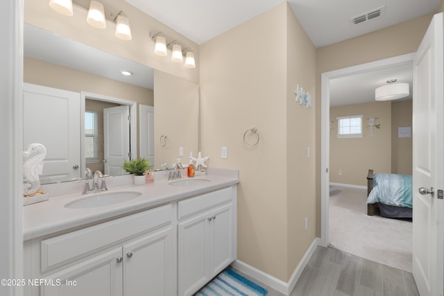 222 River Mist Dr, Saint Augustine, FL 32095 - ensuite bathroom with double vanity, baseboards, and wood finished floors