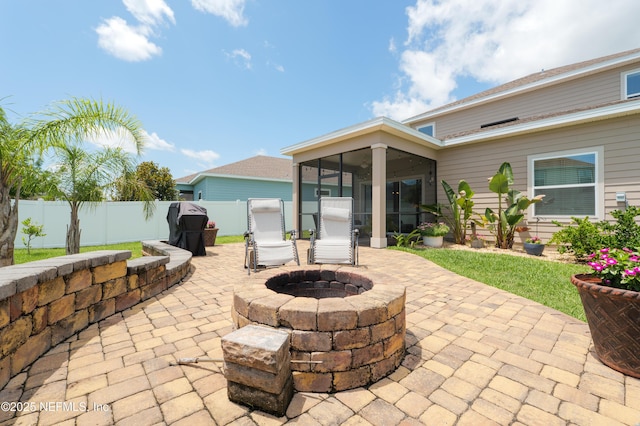 222 River Mist Dr, Saint Augustine, FL 32095 - fenced backyard with a patio area, a sunroom, and an outdoor fire pit