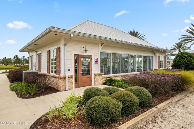 222 River Mist Dr, Saint Augustine, FL 32095 - view of front of home featuring metal roof and central AC