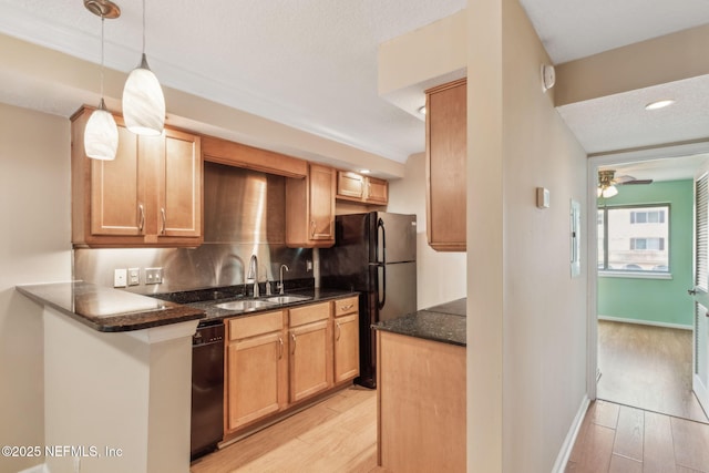 5375 Ortega Farms Blvd Unit 510, Jacksonville, FL 32210 - kitchen with a sink, black appliances, light wood-style flooring, a ceiling fan, and dark stone countertops