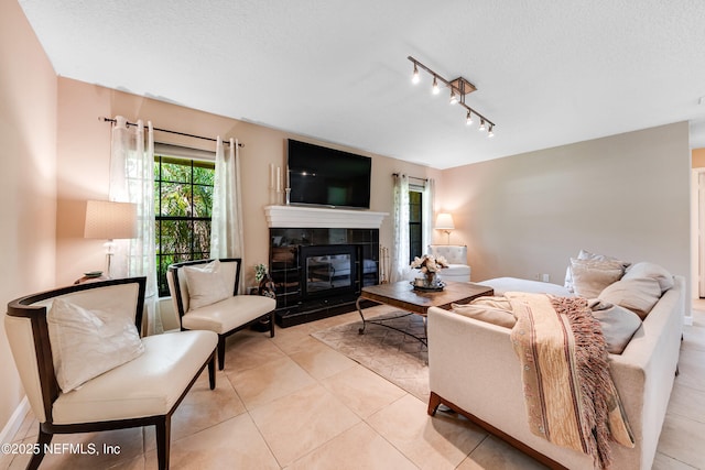 79 Sanchez Dr E, Ponte Vedra Beach, FL 32082 - tiled living room featuring a fireplace, rail lighting, and a textured ceiling
