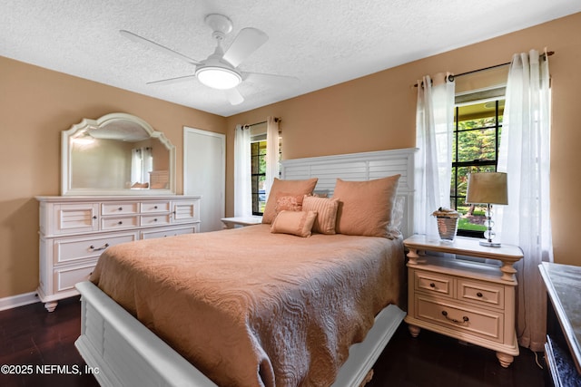 79 Sanchez Dr E, Ponte Vedra Beach, FL 32082 - bedroom featuring dark wood finished floors, a textured ceiling, baseboards, and a ceiling fan