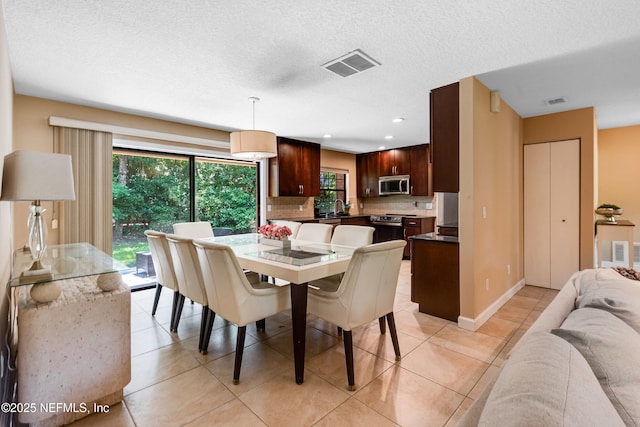 79 Sanchez Dr E, Ponte Vedra Beach, FL 32082 - dining area featuring recessed lighting, light tile patterned floors, baseboards, and a textured ceiling