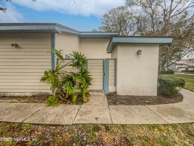 102 Courageous Ct N Unit 102, Jacksonville, FL 32233 - view of exterior entry with a gate and stucco siding