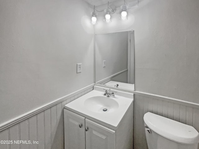 102 Courageous Ct N Unit 102, Jacksonville, FL 32233 - half bathroom with a wainscoted wall, vanity, and toilet