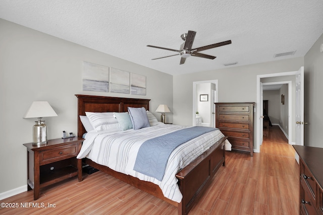 2720 Arundel Ln, Saint Augustine, FL 32092 - bedroom featuring light wood finished floors, a textured ceiling, a ceiling fan, connected bathroom, and baseboards
