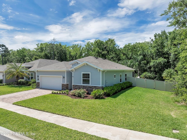 202 Purus Way, Jacksonville, FL 32259 - ranch-style house with decorative driveway, a garage, stone siding, and a shingled roof