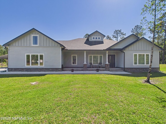 75610 Edwards Rd, Yulee, FL 32097 - view of front of home with board and batten siding, a front lawn, and roof with shingles