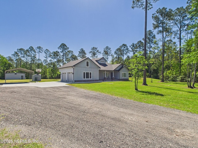 75610 Edwards Rd, Yulee, FL 32097 - view of front of home with concrete driveway, a carport, a garage, a front yard, and board and batten siding