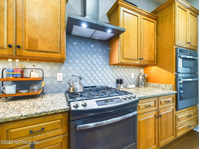 75610 Edwards Rd, Yulee, FL 32097 - kitchen featuring gas stove, wall chimney exhaust hood, double oven, and tasteful backsplash