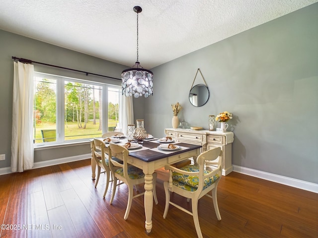75610 Edwards Rd, Yulee, FL 32097 - dining area with dark wood-type flooring, a chandelier, baseboards, and a textured ceiling