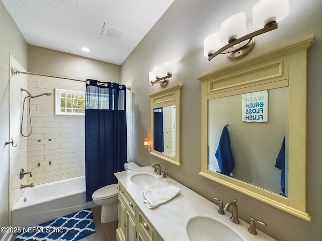 75610 Edwards Rd, Yulee, FL 32097 - full bath featuring shower / bath combination with curtain, double vanity, toilet, and a textured ceiling