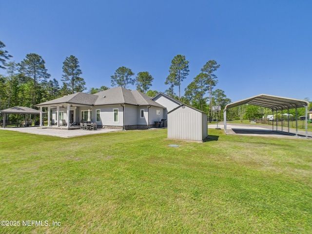 75610 Edwards Rd, Yulee, FL 32097 - rear view of house featuring a gazebo, a detached carport, a yard, ceiling fan, and an outbuilding