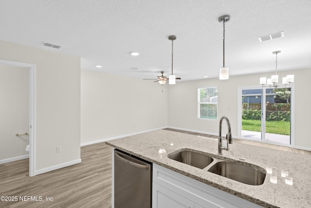 8204 Dandy Ave, Jacksonville, FL 32211 - kitchen with a sink, stainless steel dishwasher, decorative light fixtures, light wood finished floors, and white cabinetry