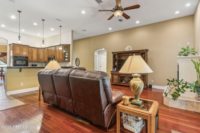 166 Mount Royal Ave, Crescent City, FL 32112 - living room with arched walkways, a ceiling fan, dark wood finished floors, recessed lighting, and baseboards