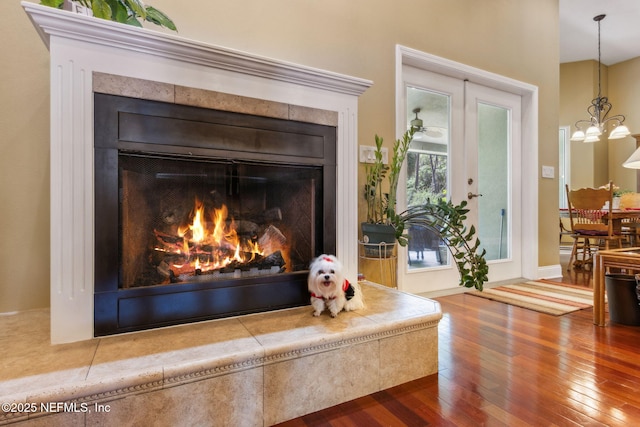 166 Mount Royal Ave, Crescent City, FL 32112 - detailed view of a tiled fireplace, wood finished floors, and a chandelier
