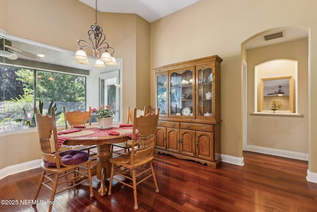 166 Mount Royal Ave, Crescent City, FL 32112 - dining area featuring dark wood-style flooring, baseboards, a ceiling fan, a high ceiling, and a chandelier