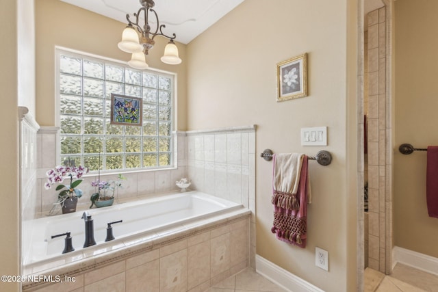166 Mount Royal Ave, Crescent City, FL 32112 - full bathroom featuring tile patterned flooring, a garden tub, a chandelier, tiled shower, and baseboards